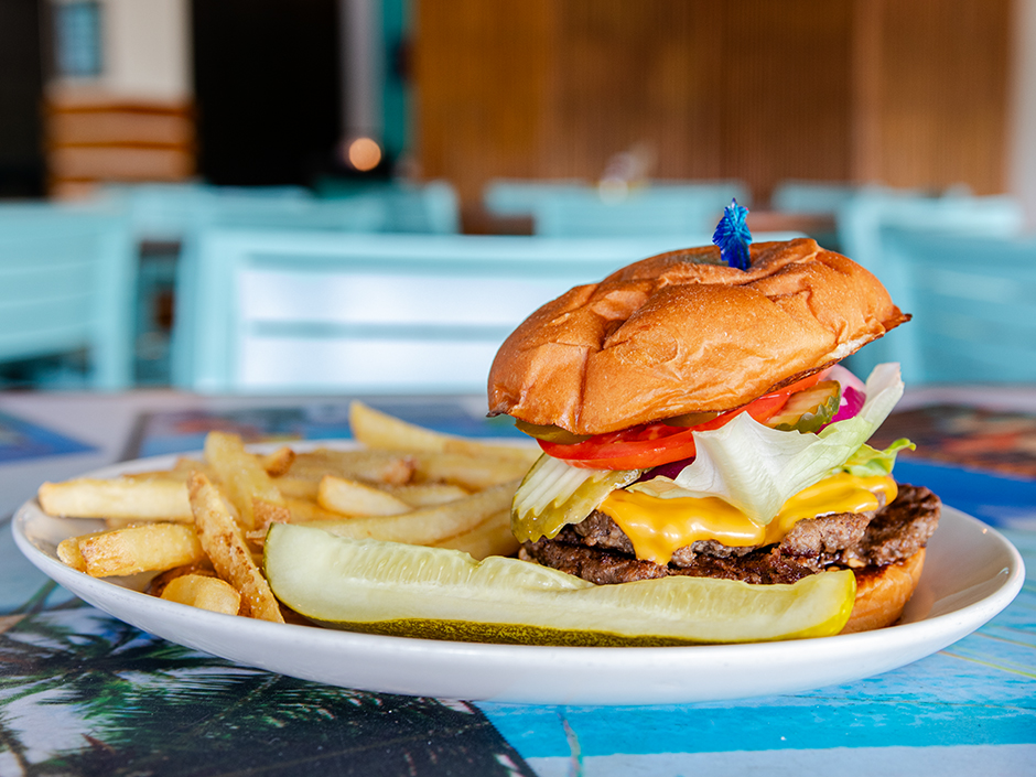 Plate of the Bacon Jam-boree Burger with a side of French fries, a dish on the new menu at Jimmy Buffett's Margaritaville in Universal CityWalk.