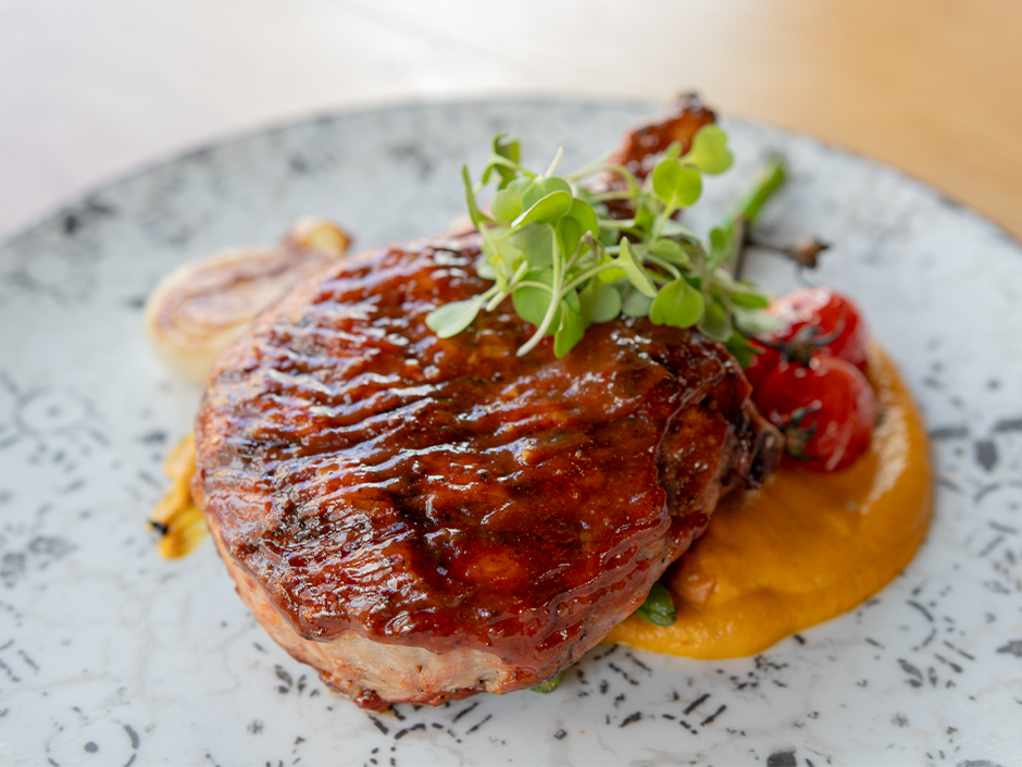 Plate of the Grilled Barbecue Pork Chop, a a dish on the new menu at Bigfire in Universal CityWalk.