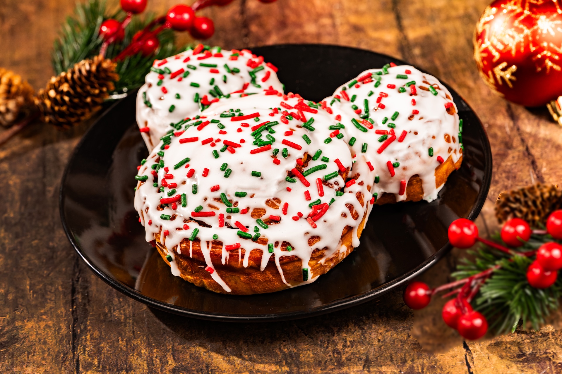 Mickey Cinnamon Roll with holiday-themed icing