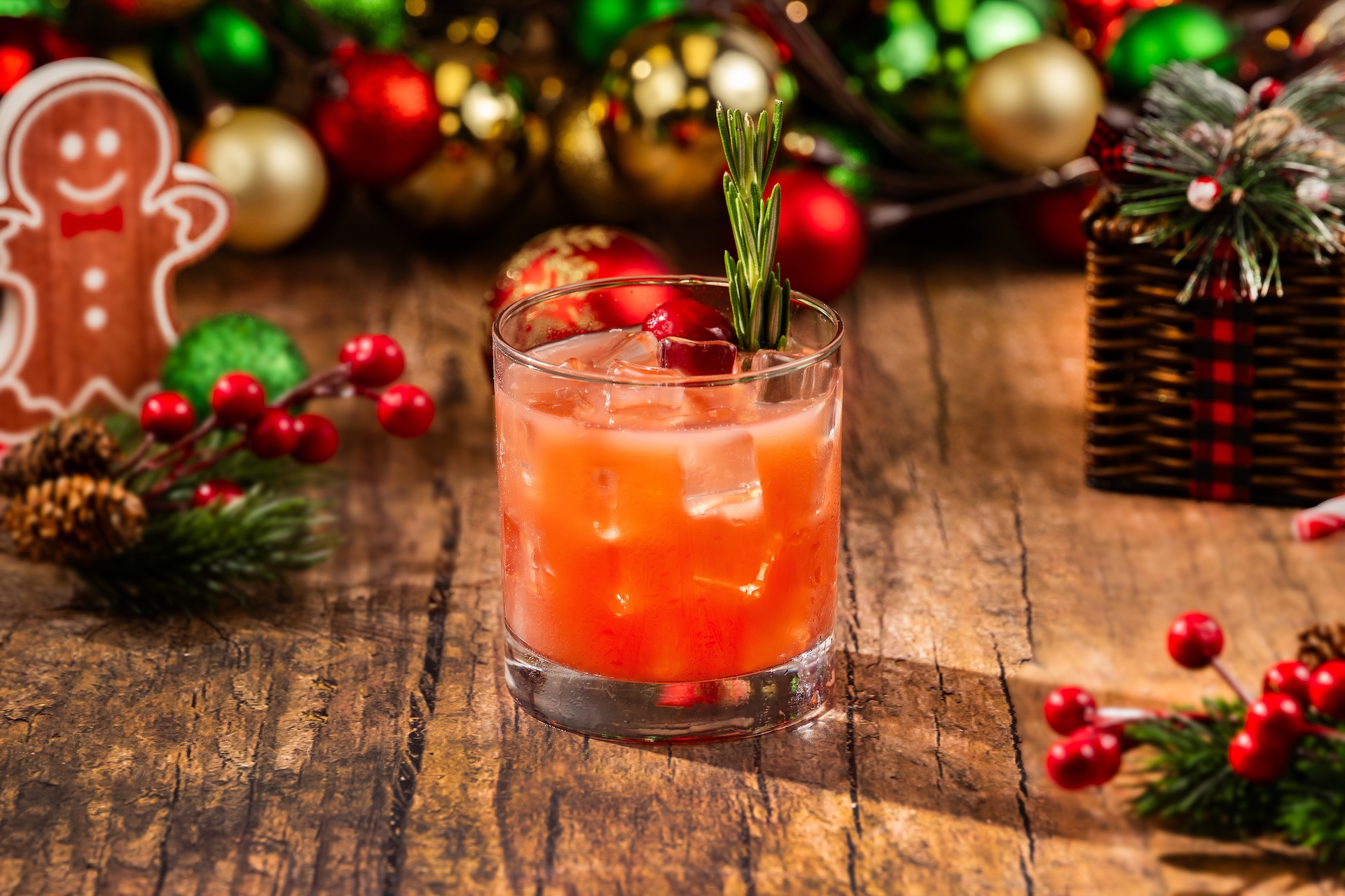 Cranberry Christmas Cocktail: Fords Gin, cane syrup, cranberry juice, and Minute Maid Orange Juice garnished with cranberries and rosemary