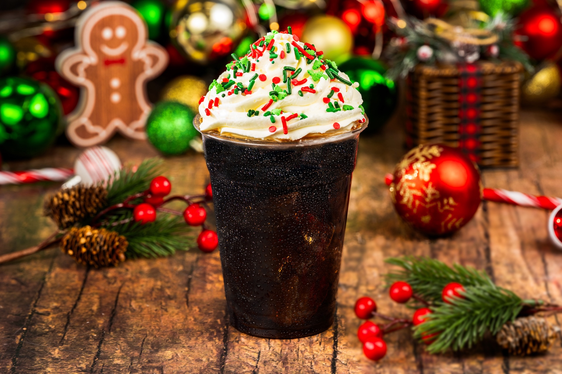 Gingerbread Cola: Coca-Cola served with gingerbread syrup, whipped cream, and festive sprinkles