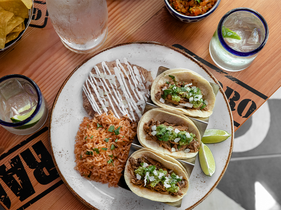 Carnita tacos with rice and beans.