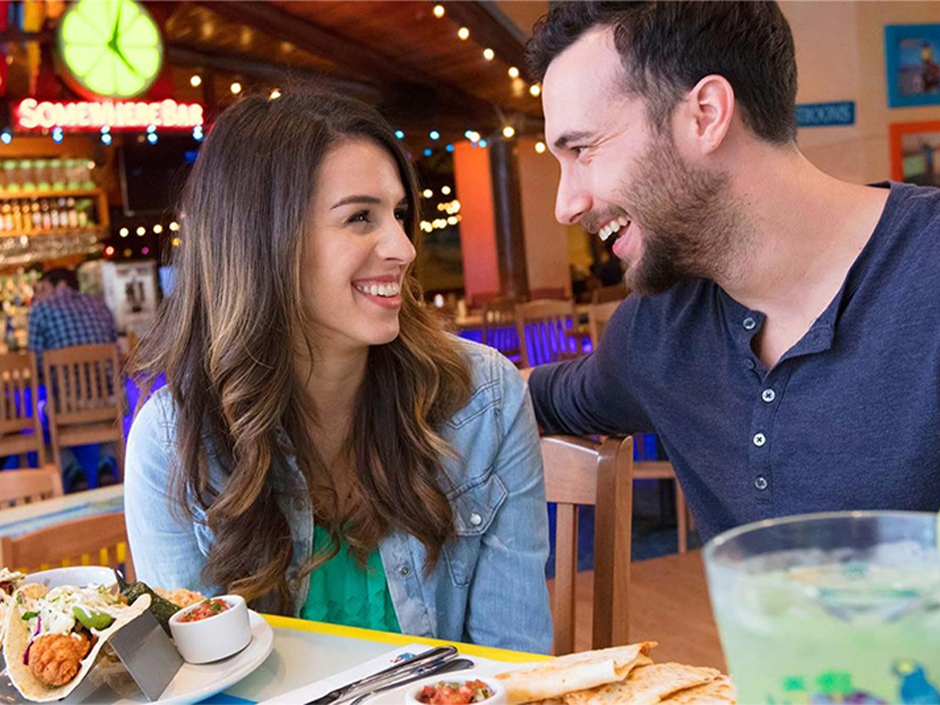A man and woman smiling at each other.